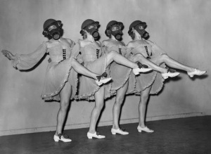 Tour Dates Available  Dancers at the Windmill Theatre in London practice a routine wearing gas masks and hard-hats with their costumes, 1940. (Hulton Archive-Getty Images)